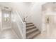 Bright entryway showcasing a staircase with white railings and wood-style tile flooring at 9249 E Sector Dr, Mesa, AZ 85212