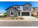 Charming two-story home featuring gray tones, a two-car garage and a welcoming front yard at 9249 E Sector Dr, Mesa, AZ 85212