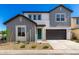 Charming two-story home featuring gray tones, a two-car garage and a welcoming front yard at 9249 E Sector Dr, Mesa, AZ 85212