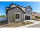 Charming two-story home featuring gray tones, a two-car garage and a welcoming front yard at 9249 E Sector Dr, Mesa, AZ 85212