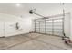 Bright and spacious two car garage featuring a door and large garage door at 9249 E Sector Dr, Mesa, AZ 85212
