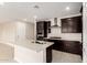 Kitchen with a large island, dark cabinetry, and stainless-steel appliances at 9249 E Sector Dr, Mesa, AZ 85212