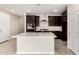 Bright kitchen featuring stainless-steel appliances, dark cabinets, and an island with sink at 9249 E Sector Dr, Mesa, AZ 85212