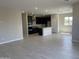 Open-concept kitchen featuring dark cabinetry, modern stainless steel appliances, and a center island, seamlessly connected to the living area at 9249 E Sector Dr, Mesa, AZ 85212