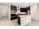 Beautiful kitchen with dark cabinetry, a center island, stainless appliances, and marble backsplash at 9249 E Sector Dr, Mesa, AZ 85212