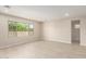 Bright living room featuring wood-style tile flooring, recessed lighting, and a large window at 9249 E Sector Dr, Mesa, AZ 85212