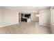 Open-concept living room flows into a modern kitchen with an island and stainless steel appliances at 9249 E Sector Dr, Mesa, AZ 85212