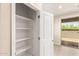 Walk-in pantry provides ample storage with built-in shelves and access to the backyard at 9249 E Sector Dr, Mesa, AZ 85212