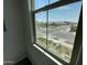 View from window of a well maintained neighborhood with an intersection, green space, and neatly lined houses in the distance at 9249 E Sector Dr, Mesa, AZ 85212
