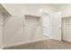 Walk-in closet featuring an open door and a rack for clothing, and neutral carpeted floor at 9249 E Sector Dr, Mesa, AZ 85212