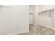 Spacious walk-in closet featuring carpeted floors and lots of closet space with racks on the wall at 9249 E Sector Dr, Mesa, AZ 85212