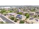 Overhead view of suburban homes, some with solar panels, and a park in the distance at 9372 W Louise Dr, Peoria, AZ 85383