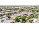 Aerial shot of a home featuring a pool, patio, landscaping, and solar panels on other homes at 9372 W Louise Dr, Peoria, AZ 85383