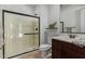 Bathroom featuring glass-enclosed shower, modern vanity, and stylish fixtures at 9372 W Louise Dr, Peoria, AZ 85383