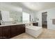 Luxury bathroom with a soaking tub, large mirrors, double sinks, and a separate shower space at 9372 W Louise Dr, Peoria, AZ 85383
