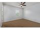 This carpeted bedroom features a ceiling fan and a window to bring in natural light at 9372 W Louise Dr, Peoria, AZ 85383