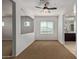Neutral bedroom with carpeted floors, an opening to the bathroom, and natural light from the window at 9372 W Louise Dr, Peoria, AZ 85383