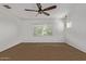 Light and bright bedroom with white walls, carpeted floor, natural light from the windows, and a ceiling fan at 9372 W Louise Dr, Peoria, AZ 85383