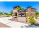 The Meadows Community Center entrance with stone and brick exterior, attractive landscaping, and clear blue sky at 9372 W Louise Dr, Peoria, AZ 85383