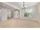 Bright dining room boasting a modern chandelier, neutral walls, and tile flooring with a view of office space at 9372 W Louise Dr, Peoria, AZ 85383