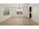 Well-lit dining room featuring neutral walls, tile floors, a modern light fixture and views to the kitchen at 9372 W Louise Dr, Peoria, AZ 85383