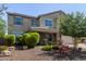 Charming stucco two-story home with desert landscaping, a covered porch, and a two-car garage at 9372 W Louise Dr, Peoria, AZ 85383