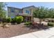 Charming stucco two-story home with desert landscaping, a covered porch, and a paver driveway at 9372 W Louise Dr, Peoria, AZ 85383