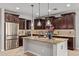 Bright kitchen featuring a large island, stainless steel appliances, and custom cabinets at 9372 W Louise Dr, Peoria, AZ 85383