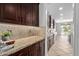 Beautiful kitchen details, including granite countertops, mosaic backsplash, and dark wood cabinets at 9372 W Louise Dr, Peoria, AZ 85383