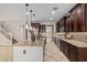 Gourmet kitchen featuring granite counters, stainless appliances, and elegant dark wood cabinetry at 9372 W Louise Dr, Peoria, AZ 85383
