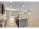 View of the kitchen island and sink area that opens to the backyard pool and living area at 9372 W Louise Dr, Peoria, AZ 85383