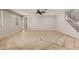 Spacious living room featuring tile flooring, staircase, ceiling fan, and natural light at 9372 W Louise Dr, Peoria, AZ 85383