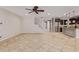 Open floor plan with tile flooring, staircase, and seamless flow into the kitchen at 9372 W Louise Dr, Peoria, AZ 85383