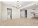 Open living room with tile flooring, neutral walls, a ceiling fan, and a view of the kitchen at 9372 W Louise Dr, Peoria, AZ 85383