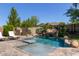 Backyard pool with waterfall feature surrounded by desert landscaping at 9372 W Louise Dr, Peoria, AZ 85383