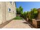 Side yard with a brick walkway, lush landscaping, and planters at 9372 W Louise Dr, Peoria, AZ 85383