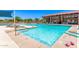 Sparkling swimming pool area with lounge chairs and covered seating area, perfect for relaxation at 9372 W Louise Dr, Peoria, AZ 85383
