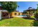 A beautiful backyard with a pool, green grass, a gazebo and a privacy fence at 9714 N 55Th Dr, Glendale, AZ 85302