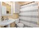 Charming bathroom with white fixtures, cabinet storage, and shower at 9714 N 55Th Dr, Glendale, AZ 85302