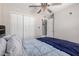 Comfortable bedroom with a ceiling fan, closet, and doorway to the adjoining bathroom at 9714 N 55Th Dr, Glendale, AZ 85302