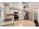 Traditional kitchen with stainless steel appliances, tile floors, ceiling fan, and plenty of cabinet space at 9714 N 55Th Dr, Glendale, AZ 85302
