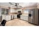 Traditional kitchen featuring updated appliances, travertine tile floors, and ample cabinet space at 9714 N 55Th Dr, Glendale, AZ 85302