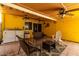 Covered patio boasts ceiling fans, seating, and an outdoor laundry area at 9714 N 55Th Dr, Glendale, AZ 85302