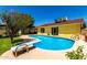 Backyard pool with diving board, patio, and bright yellow home exterior beneath a clear blue sky at 9714 N 55Th Dr, Glendale, AZ 85302