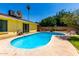 Backyard pool with patio and bright yellow home exterior offering relaxation and enjoyment at 9714 N 55Th Dr, Glendale, AZ 85302