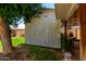 Exterior of a shed in the backyard, featuring double doors, trees and a yard at 9714 N 55Th Dr, Glendale, AZ 85302