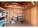 Interior view of a shed with plywood walls, shelving, and a concrete floor at 9714 N 55Th Dr, Glendale, AZ 85302