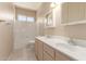 Well-lit bathroom with a double sink vanity, tiled floor, and a shower over tub at 986 W Citrus Way, Chandler, AZ 85248