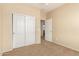 Bedroom featuring neutral walls and carpeting, closet with sliding doors and doorway to hall at 986 W Citrus Way, Chandler, AZ 85248