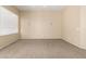 Spacious bedroom with neutral carpet, blank walls, and a window with blinds at 986 W Citrus Way, Chandler, AZ 85248